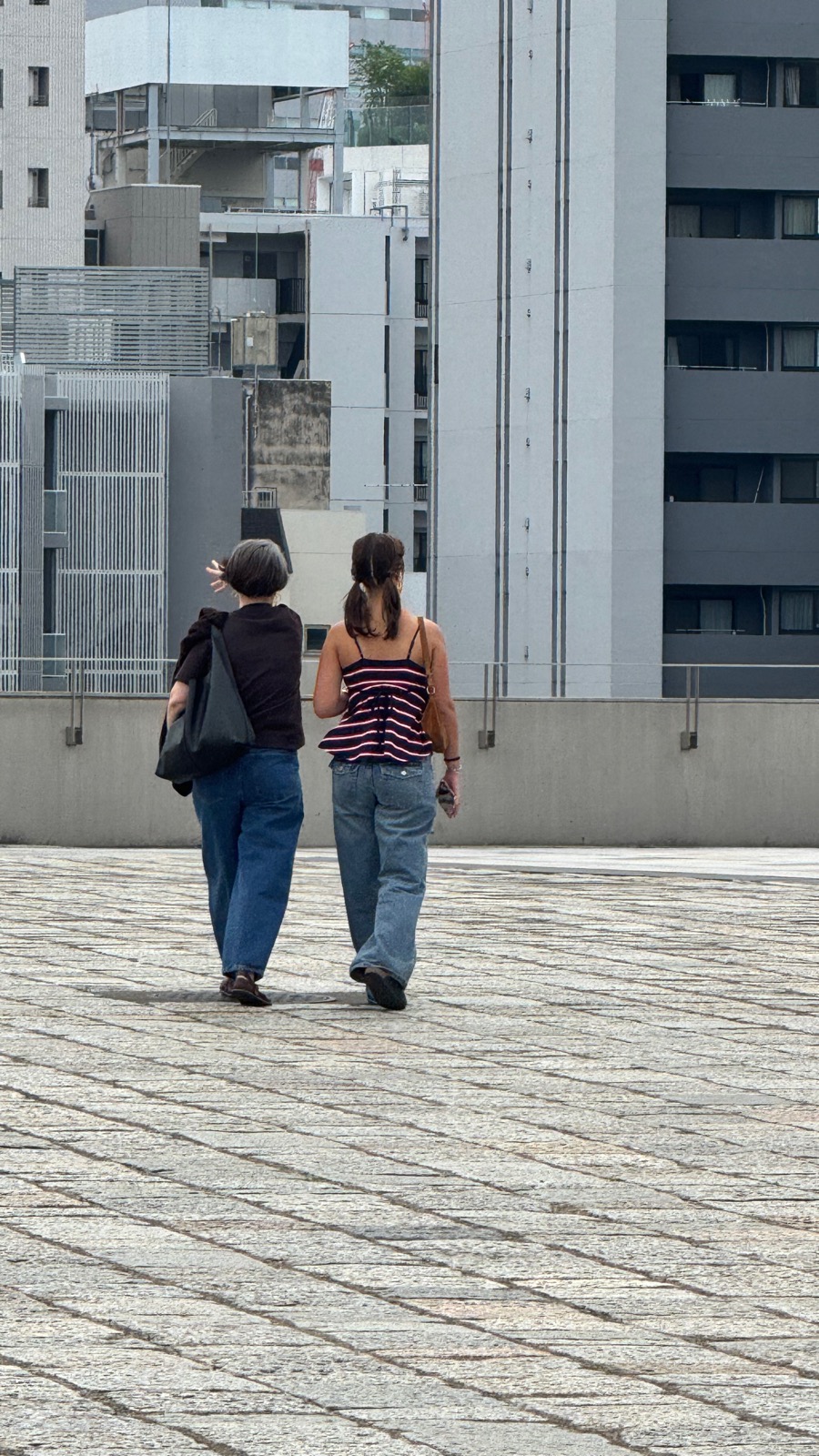 Natalia and Seraphima walking past Yoyogi National Stadium